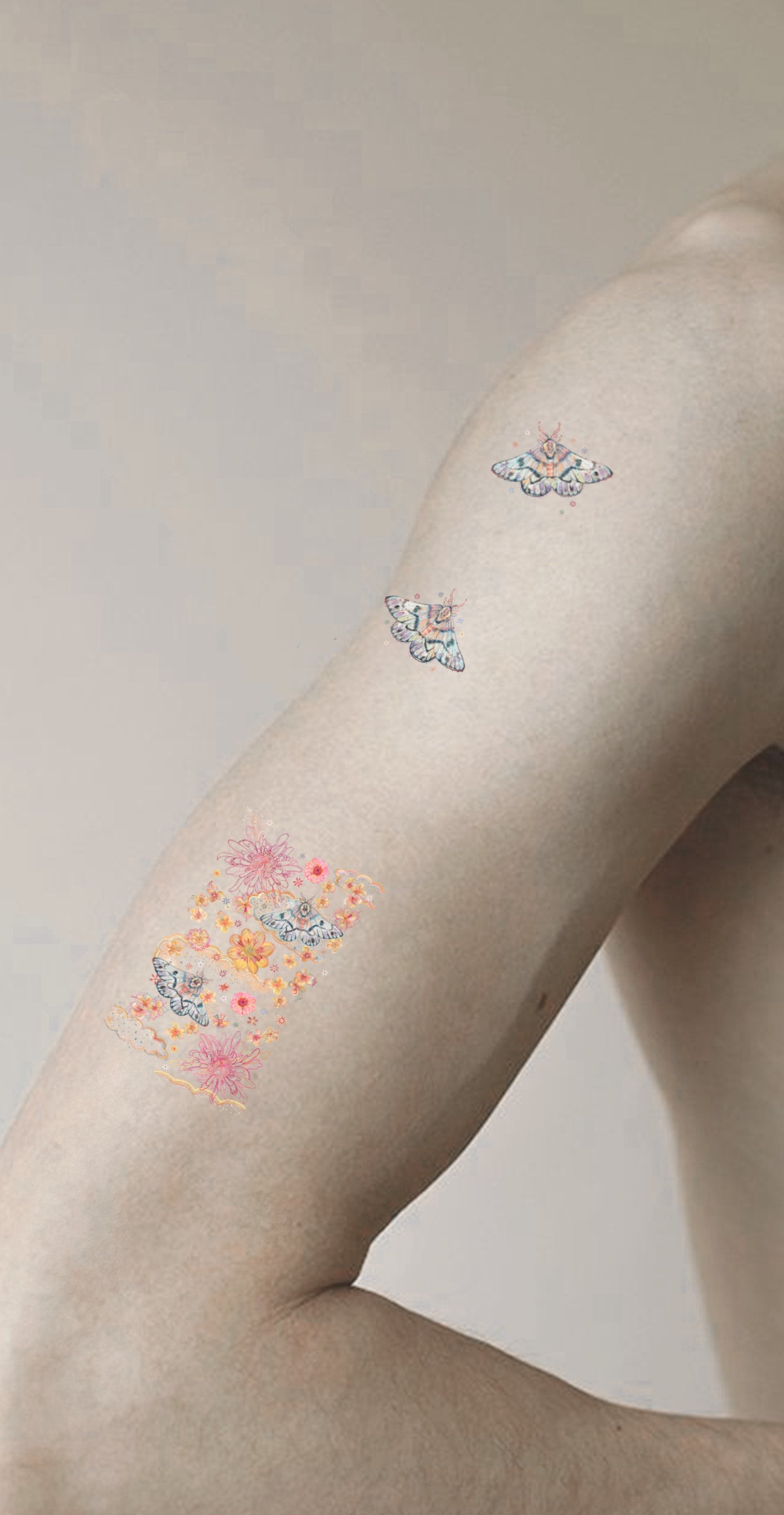 Decorative temporary tattoos on a person's arm against a neutral background