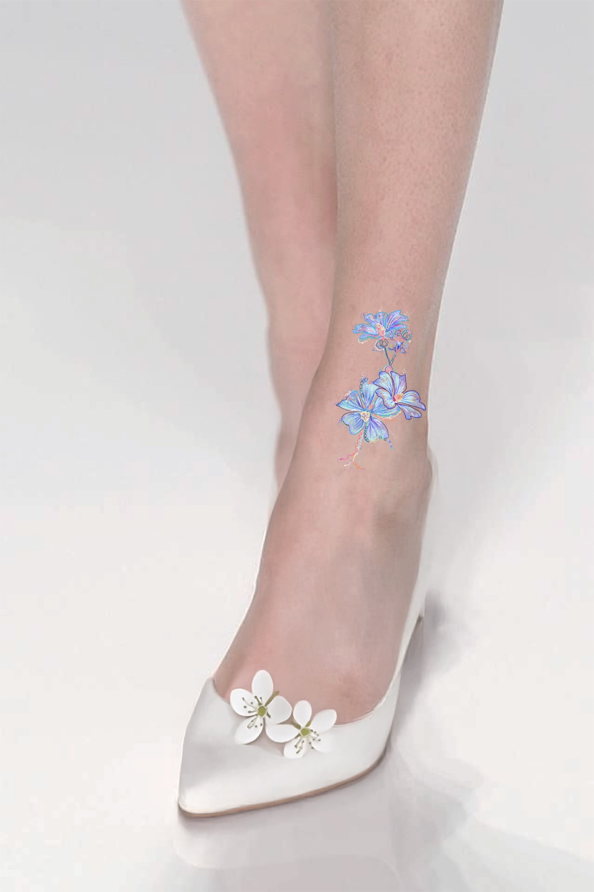 Sheer stockings with floral design, paired with white shoes on light gray background
