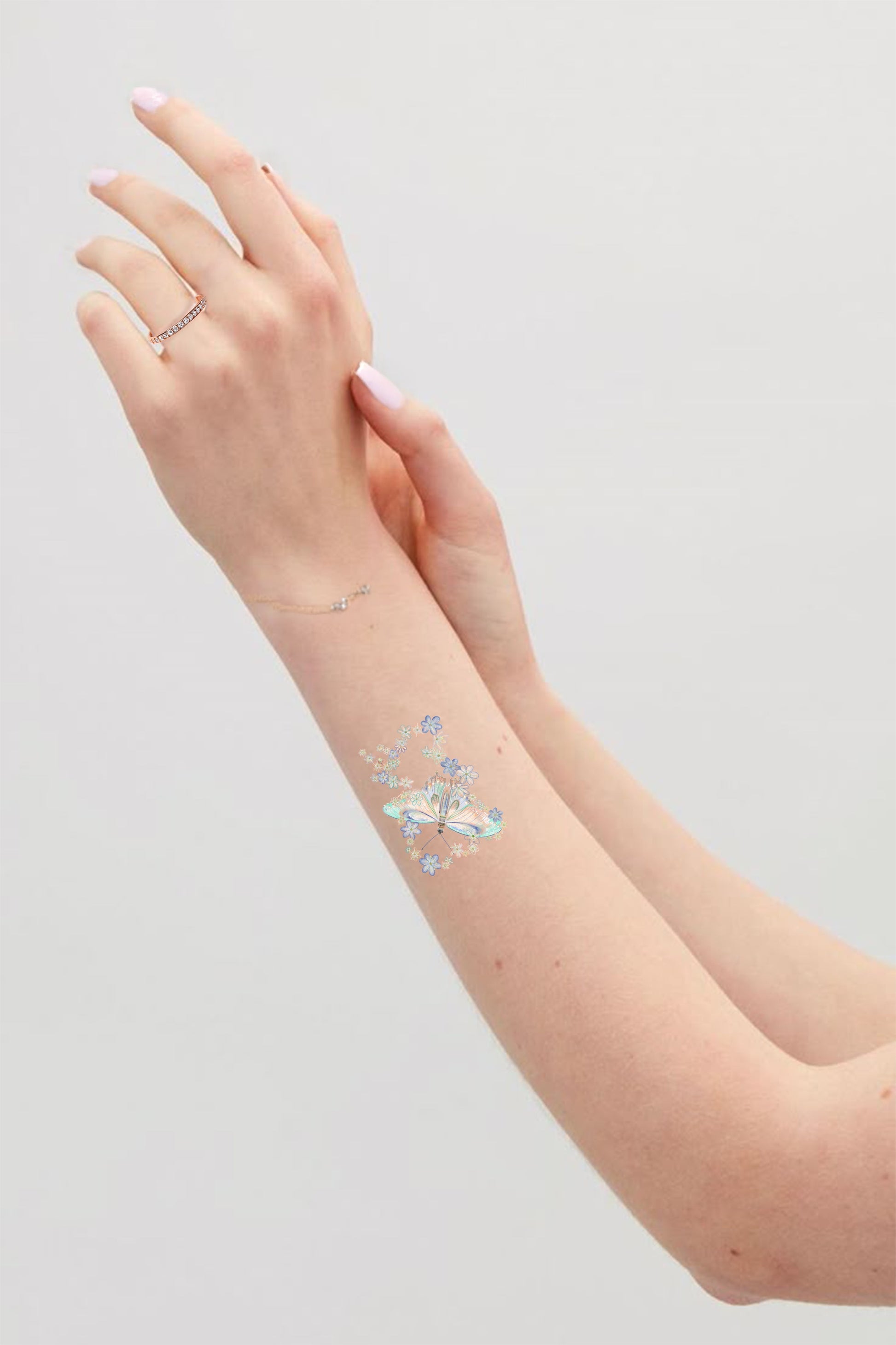 Hand with a temporary tattoo on a light gray background