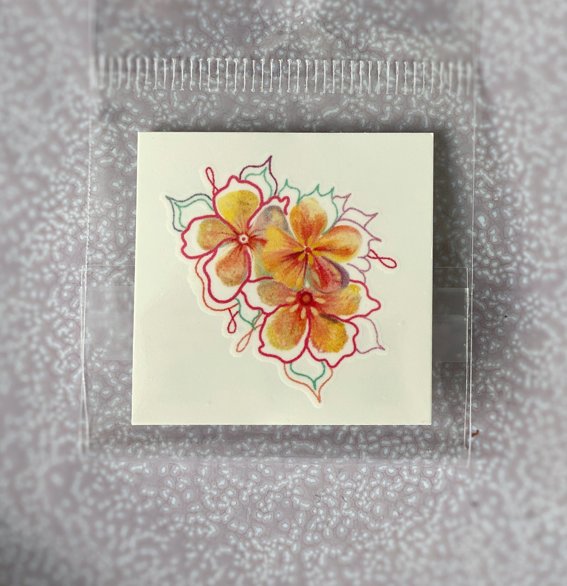 Close-up of a small floral trio temporary tattoo, 1.5 inch, waterproof and stick-on