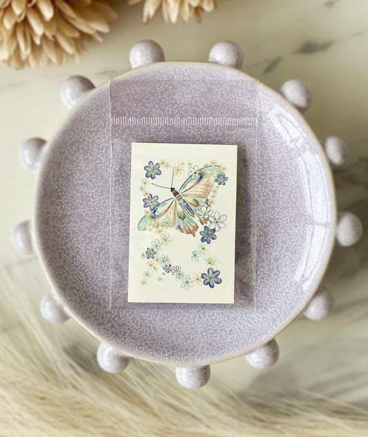 Close-up of blue-green butterfly floral temporary tattoo