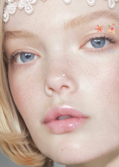 Close-up of a person with decorative headband and floral makeup on face